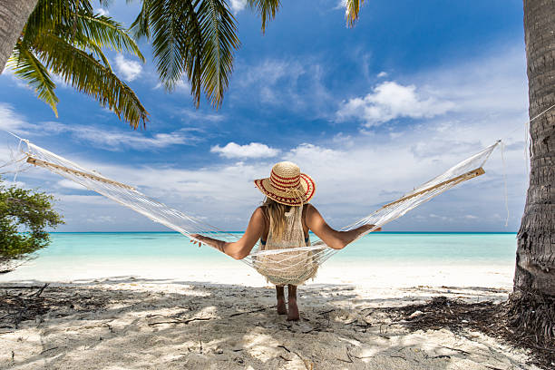 Woman relaxing in a hammock during a solo beach trip