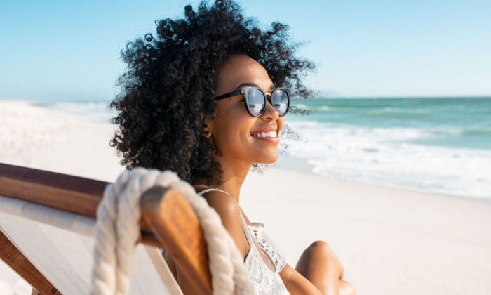 Solo female traveler enjoying au naturel beach vacation at Serenity in The Bahamas